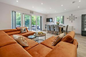 a living room with a couch and a dining room at Trevone in Saint Mawgan