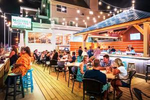 a group of people sitting at tables in a restaurant at The Tides at Hampton Beach in Hampton