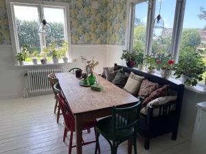 a dining room with a table and a couch at Strömma Farmlodge B&B in Tvååker