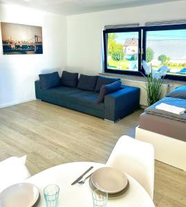 a living room with a couch and a table at Messewohnung Ferienwohnung 102 in Cologne