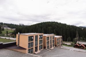an office building with a mountain in the background at Brooklyn 2 in Yablunytsya