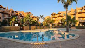 a swimming pool in front of some apartment buildings at Vista Bonita - Mar Menor Golf Resort in Torre-Pacheco