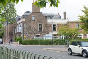 a white car parked on a street in front of a building at Park Hotel in Montrose