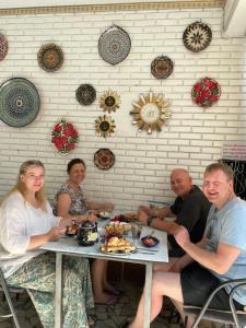 a group of people sitting at a table with food at Madina-Mehribon in Bukhara +18 photos