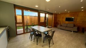 a living room with a table and chairs and a couch at Apart Sei - Rada Tilly - in Rada Tilly