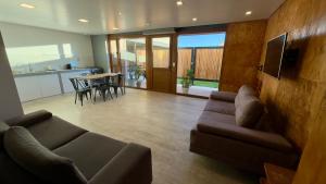 a living room with a couch and a table at Apart Sei - Rada Tilly - in Rada Tilly