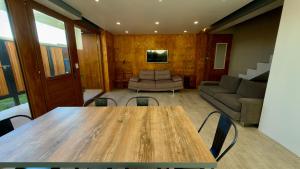 a room with a table and chairs and a couch at Apart Sei - Rada Tilly - in Rada Tilly +8 photos