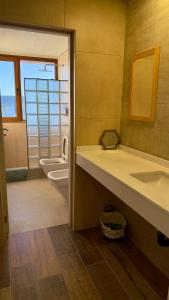 a bathroom with a sink and a tub and a toilet at Apart Sei - Rada Tilly - in Rada Tilly