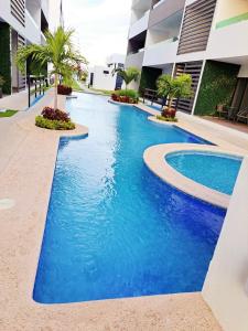 a swimming pool in front of a building at Marina Cerritos de Lujo - Azul Cielo - 5 Albercas in Mazatlán