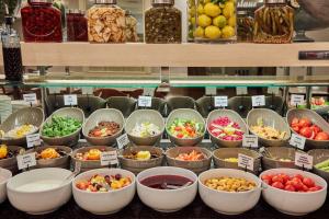 a display of bowls of different types of food at Konak Hotel Taksim in Istanbul +24 photos