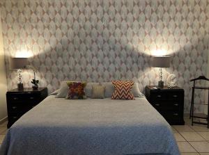 a bedroom with a large bed with two night stands at Casa Arboledas in Reynosa