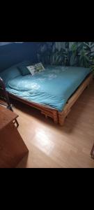 a bed sitting on the floor in a room at Havre de paix à la campagne in Ronchamp