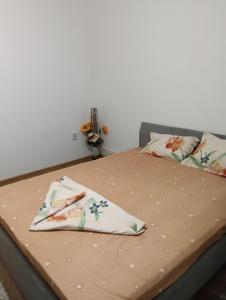 a bed with two pillows on top of it at casa lidia in Brăila