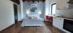 a small bedroom with a bed and a kitchen at Antica Fontana in Bernezzo