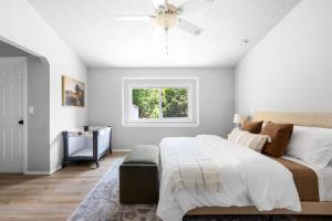 a bedroom with a bed and a ceiling fan at Stylish Renovation, Perfect for Families & Pets, Garage Parking, Sleeps 10 in Boise