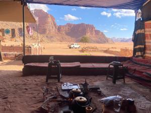 a room with a couch and a view of the desert at Wadi Rum Authentic Camp in Wadi Rum