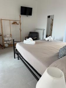 a bedroom with two beds and a flat screen tv at Casa Vacanza IsaCla al Castello in Montemiletto