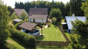 a house with a car parked in a yard at Chata Suchý in Suchý