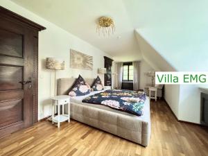 a bedroom with a bed in a room at Luxury Holidays Villa EMG Munich with Forest and Lake - Moosburg an der Isar in Moosburg