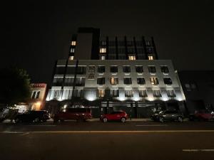 a building with cars parked in front of it at night at LIV Hotel Bronx GRAND OPENING in Bronx