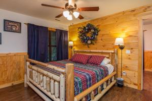 a bedroom with a bed and a ceiling fan at The Settlement by American Patriot Getaways in Williamsburg