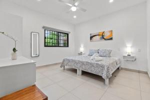 a white bedroom with a bed and a window at Romantic house Bucerías Two Turtles in Bucerías +28 photos