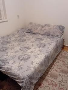 Una cama en un dormitorio con una manta. en apartman centar sarajevo, en Sarajevo