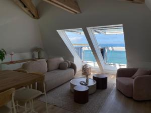 a living room with a view of the ocean at Santec, T3 duplex, face à la mer in Santec +15 photos