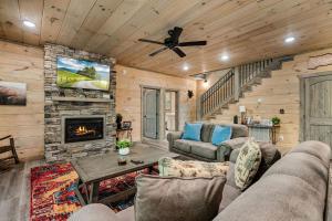a living room with a couch and a fireplace at The Spirit Bear Lodge by American Patriot Getaways in Glade