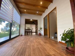 an empty living room with wooden floors and large windows at Cómoda cada modular in San Esteban