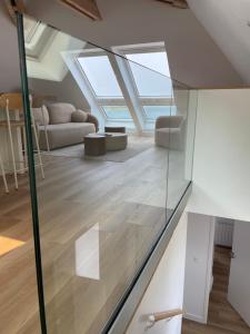 a room with skylights and a living room with wood floors at Santec, T3 duplex, face à la mer in Santec