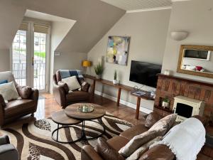 a living room with a couch and a fireplace at Lahinch Central 3-Bed Retreat in Lahinch