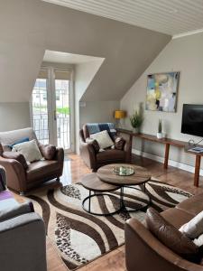 a living room with couches and a coffee table at Lahinch Central 3-Bed Retreat in Lahinch