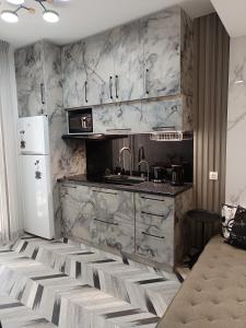 a kitchen with a sink and a refrigerator at Olga Luxury Apartment in Paralia Katerinis