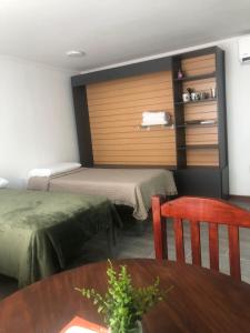 a room with two beds and a table and a chair at Moon Apart-hotel in Florida