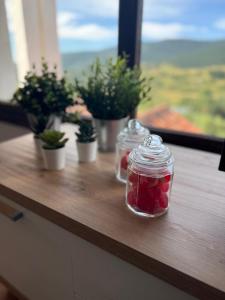 a wooden counter with jars and potted plants on it at el mirador de ona in Valdelinares