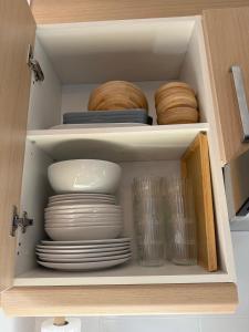 a cabinet filled with plates and bowls and dishes at el mirador de ona in Valdelinares