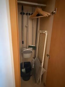 a bathroom with a mop and a broom in a closet at el mirador de ona in Valdelinares