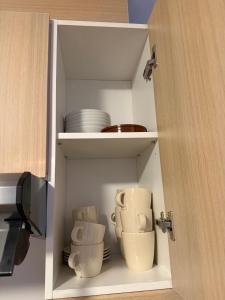 a cupboard with cups and plates in it at el mirador de ona in Valdelinares +19 photos