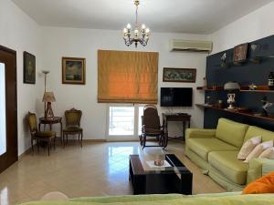 a living room with a couch and a table at Villa ILIRIAN in Laç