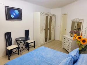 a bedroom with a bed and a table and chairs at RDR Apartments in Santa Catharina