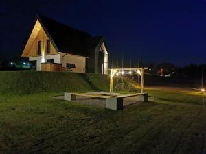 a bench in front of a house at night at Kącik Na Dolinie in Groń