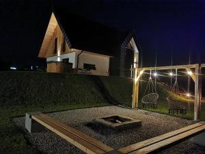 a backyard with a fire pit at night at Kącik Na Dolinie in Groń