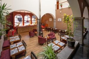a restaurant with tables and chairs and a counter at Mamasara Cusco in Cusco