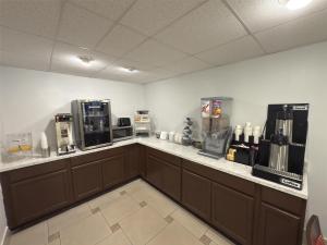 a coffee shop with a counter with coffee machines at SureStay by Best Western Jacksonville Airport in Jacksonville