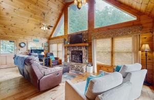 a living room with a couch and a fireplace at 4 Bed 4 Bath Vacation home in Sylva in Sylva
