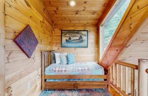 a bedroom in a log cabin with a bed in it at 4 Bed 4 Bath Vacation home in Sylva in Sylva