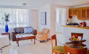 a living room with a couch and a table at Portal del Rodeo ApartaHotel - Arkadia Mall in Medellín