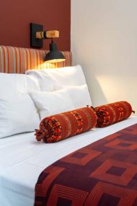 two pillows on a bed in a hotel room at Mamasara Machupicchu in Machu Picchu +30 photos
