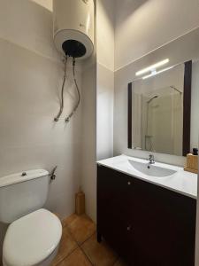 a bathroom with a toilet and a sink at El mirador de Espadán in Segorbe